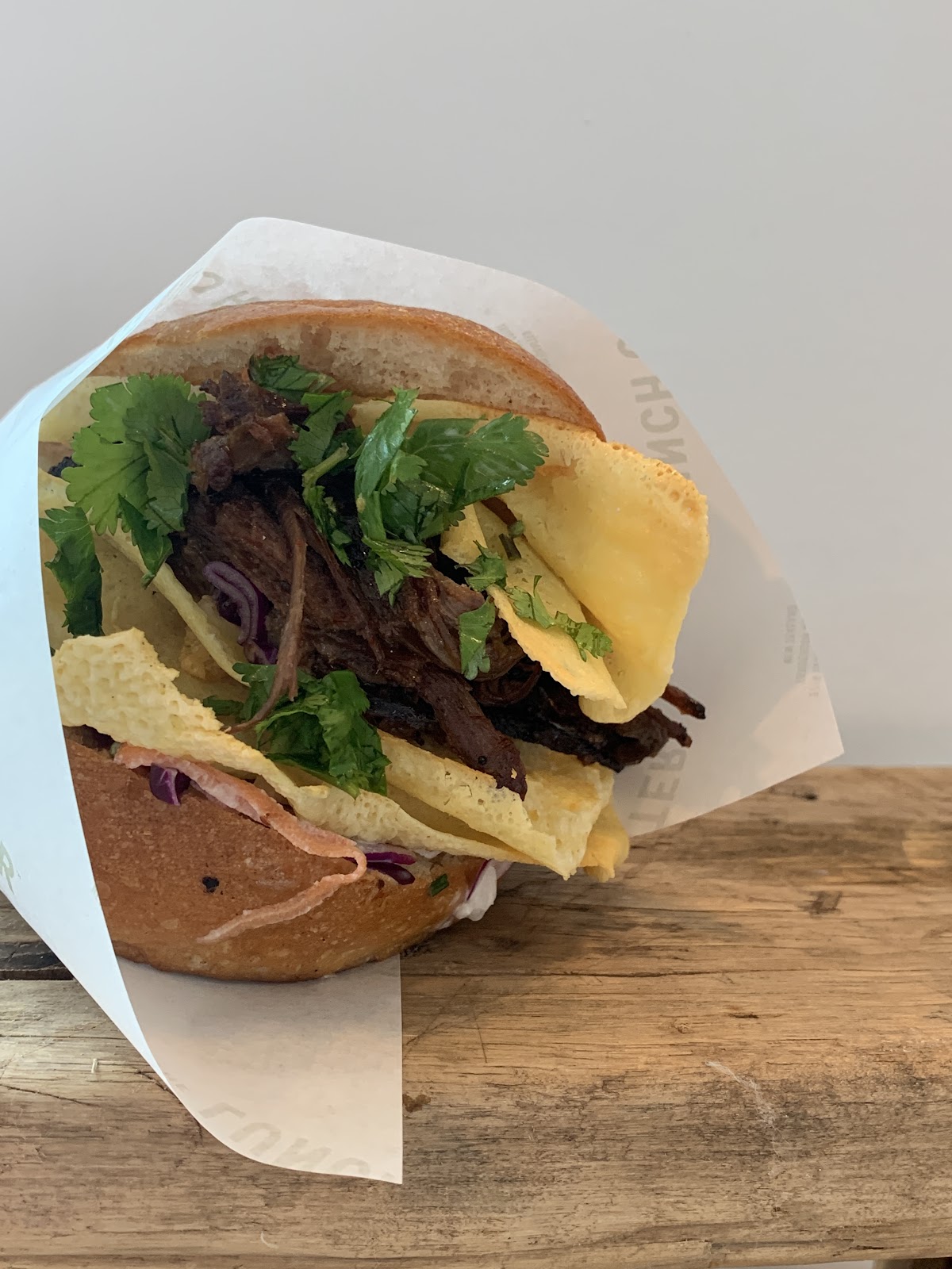 Loaded brisket sandwich in branded Lunch Counter wrap